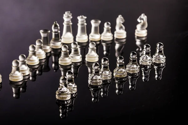 Glass Chess Pieces Arranged Dark Transparent Surface — Stock Photo, Image