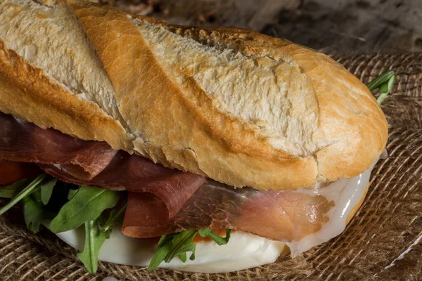 stock image baguette with raw ham and mozzarella