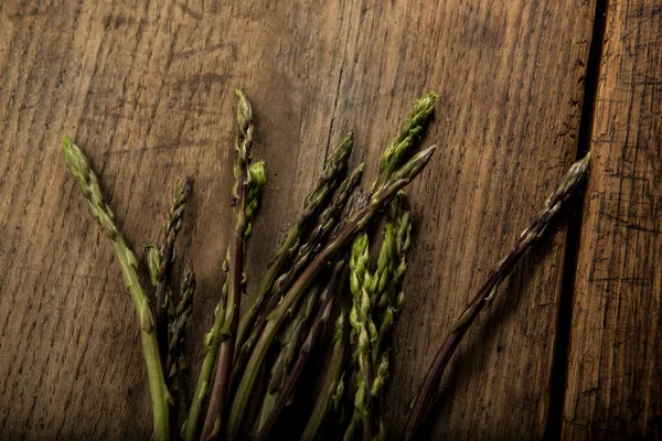 stock image Fresh asparagus isolated on wooden table