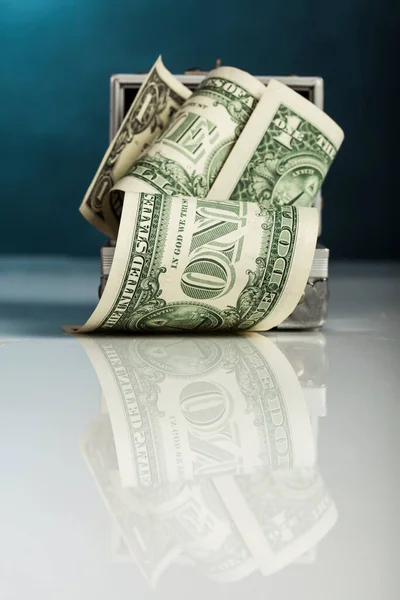 stock image Rolled dollar bills, on a blue background