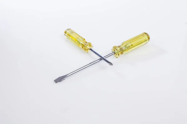Two Crossed Screwdrivers Yellow Handle White Background — Stock Photo, Image
