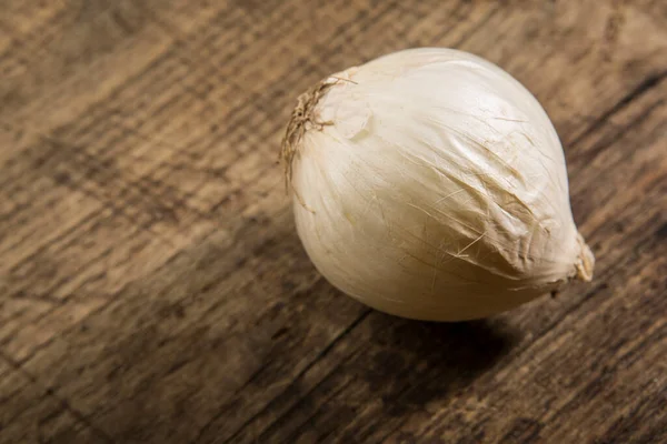 stock image White garlic on wooden background 