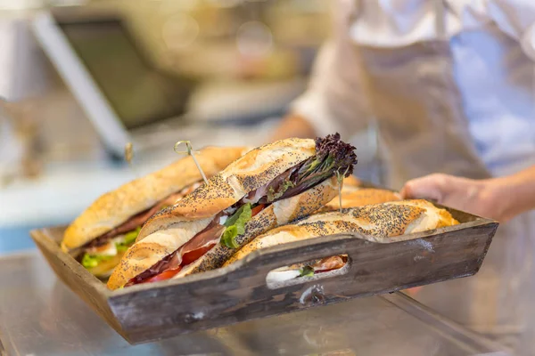 stock image Tray with stuffed sandwiches brought by a waiter