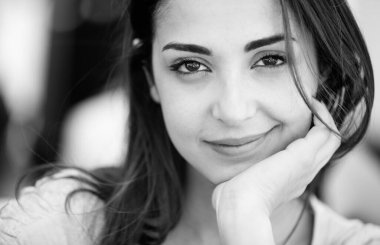 Çevreye dalmış siyah saçlı bir kızın siyah beyaz fotoğrafı.