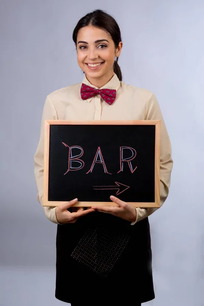 waitress is holding a blackboard with \