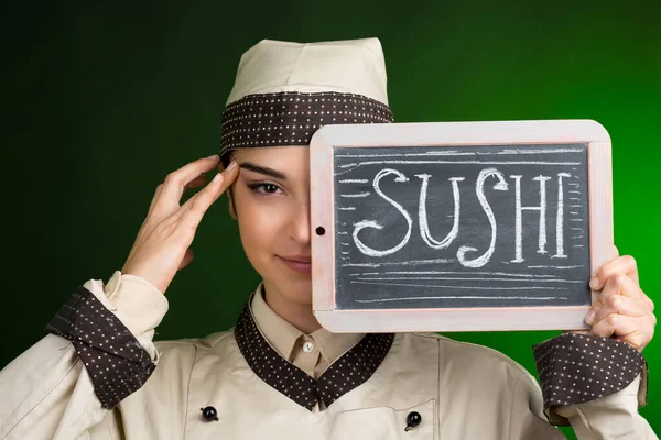 Cocinero Europeo Uniforme Sostiene Una Pizarra Con Sushi Escrito Aislado — Foto de Stock