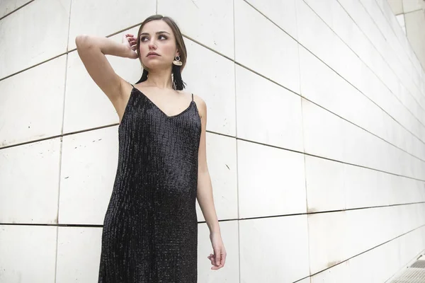 stock image portrait of beautiful young woman in stylish black dress on urban background