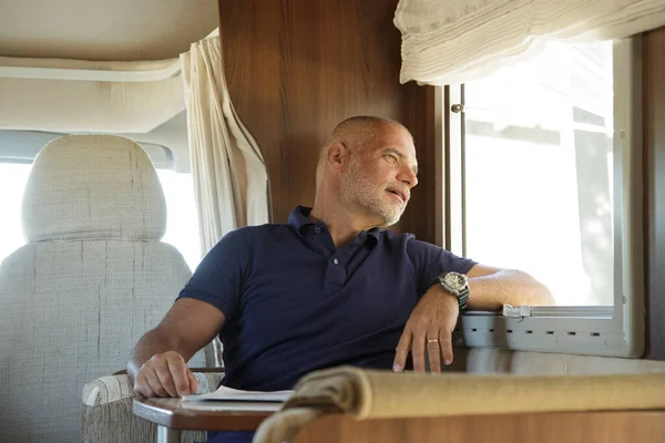 Bald Middle Aged Man Looks Out Window Serious Expression Sitting — Stock Photo, Image