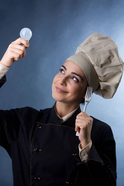 Chef Woman Chef Uniform Holds Light Bulb Her Hand Signify — Stock Photo, Image