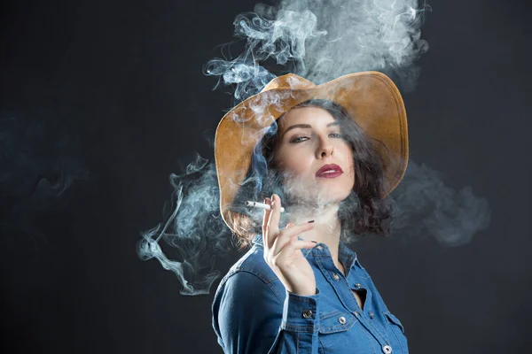 Brunette Girl Denim Shirt Cowboy Hat Smokes Cigarette Producing Lot — Stock Photo, Image