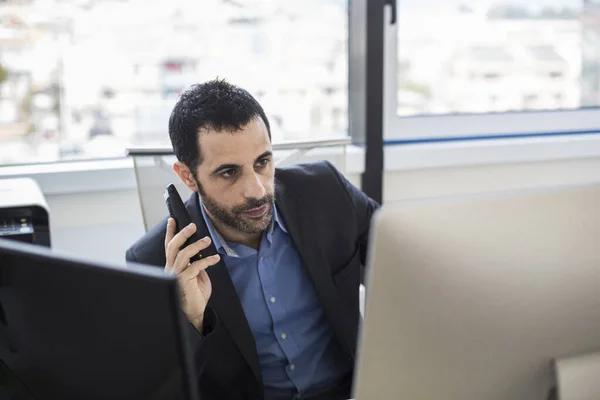 stock image manager dressed in jacket and shirt works sitting in his office workplace