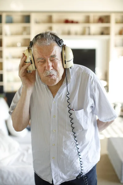 Starší Muž Poslouchající Hudbu Posteli — Stock fotografie
