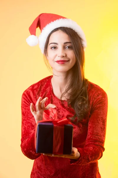 Молодая Брюнетка Одета Красное Шляпой Санта Клауса Держа Руке Подарочную — стоковое фото