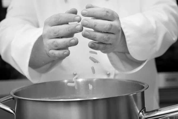 Black White Photo Chef Putting Noodles Pot Kitchen Closeup — Stock Photo, Image