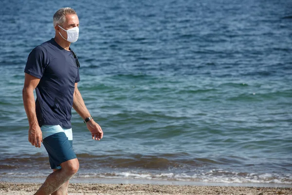 Fifty Year Old Man Protective Mask Blue Shirt Stands Beach — Stock Photo, Image