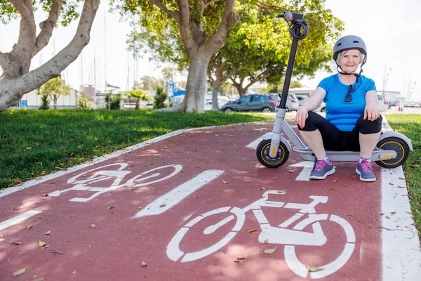 stock image senior woman sitting on scooter