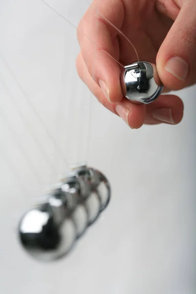 Newton Cradle Pendulums Steel Kinetic Balls Hand Pulling One — Stock Photo, Image