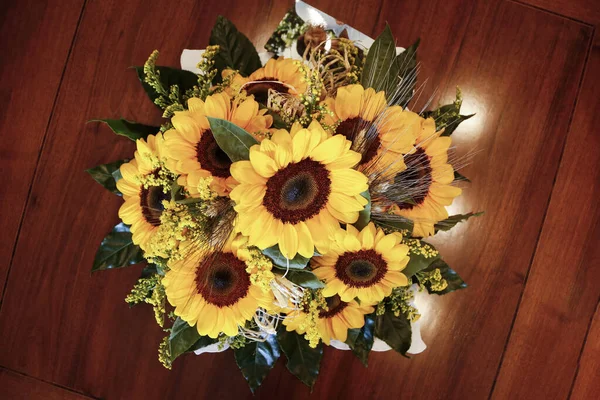 beautiful bouquet of sunflowers on wooden surface