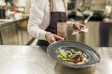 Şef mutfakta balık hazırlıyor. 