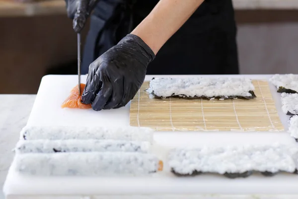 Chef Hands Gloves Cutting Sushi Roll — Stock Photo, Image