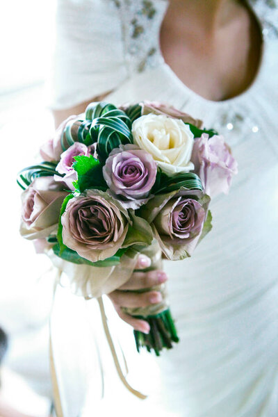 wedding bouquet of flowers in the hands of the bride 