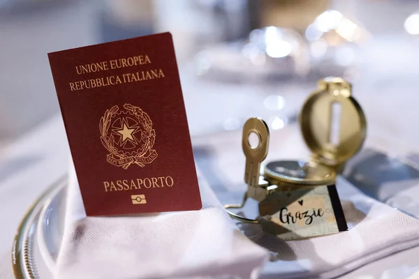 close-up view of italian passport and wedding reception in italy