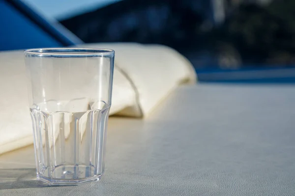 ホテルのバルコニーのテーブルにあるプラスチック製の容器の中の水は — ストック写真