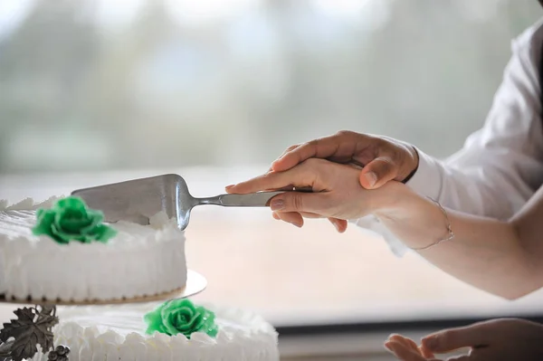 stock image a young woman decorating a cake with flowers 