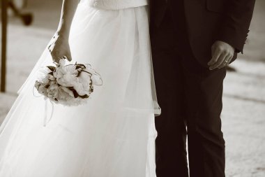 Gelin ve damat el ele tutuşuyorlar. 