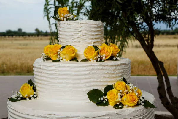 beautiful wedding cake with yellow flowers