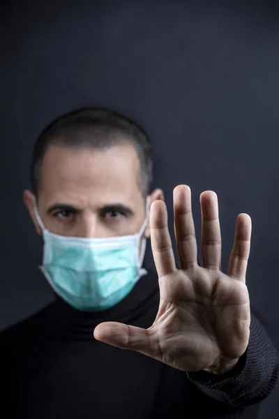 Man Shaved Hair Wearing Surgical Mask Black Sweater Gesticulates Sends — Stock Photo, Image