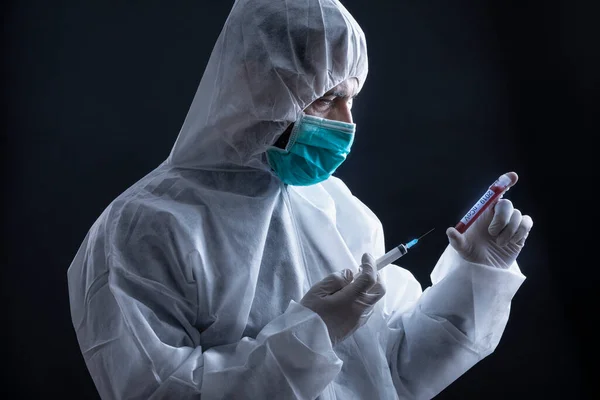 Doctor Protective Suit Mask Holding Coronavirus Blood Test Tube Syringe — Stock Photo, Image