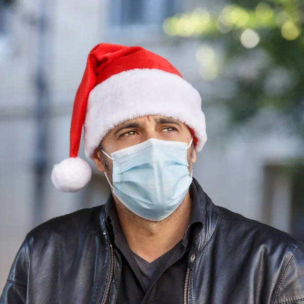 Man Santa Hat Leather Jacket Surgical Mask Looks Sad Urban — Stock Photo, Image