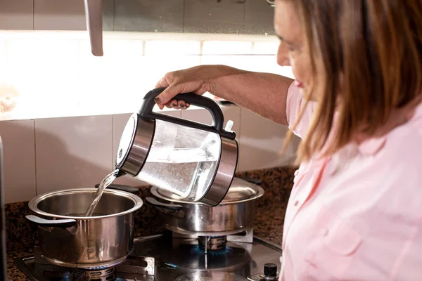 Woman Kitchen Pours Water Kettle Pan — Stock Photo, Image