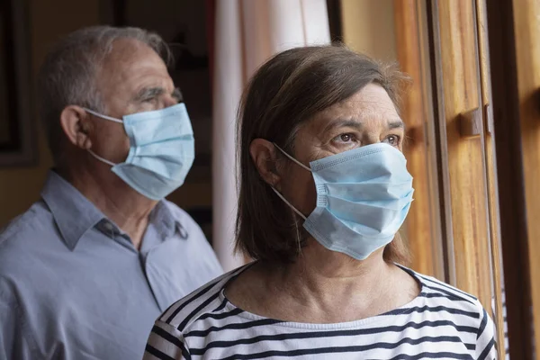 Elderly Couple Wearing Face Masks Watch World Home Window — Stock Photo, Image