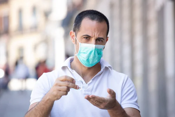 Dark Haired Man White Polo Facial Mask Disinfects His Hands — Stock Photo, Image