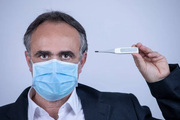 Portrait of man wearing a surgical mask, jacket and shirt, isolated on background