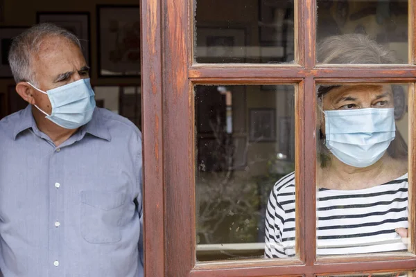 Elderly Couple Wearing Face Masks Watch World Home Window — Stock Photo, Image