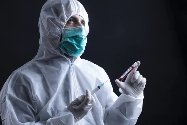 Doctor Protective Suit Mask Holding Coronavirus Blood Test Tube Syringe — Stock Photo, Image