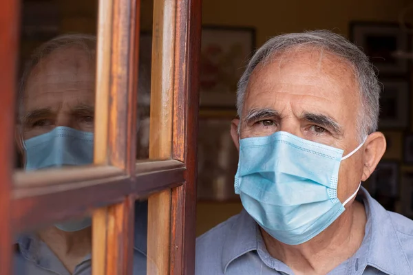 Senior Man Mask Looking Out Window Home — Stock Photo, Image