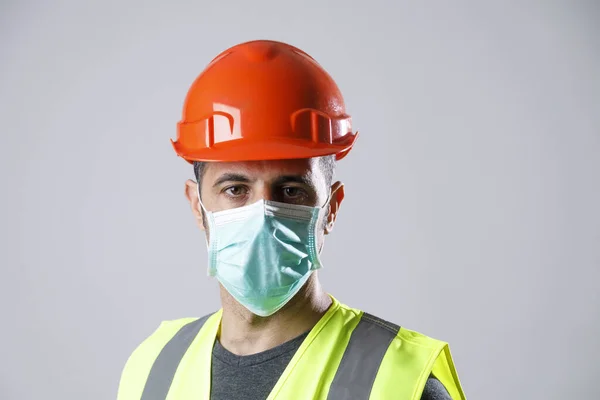 Worker Yellow Protective Helmet Vest Surgical Mask Isolated Gray Background — Stock Photo, Image
