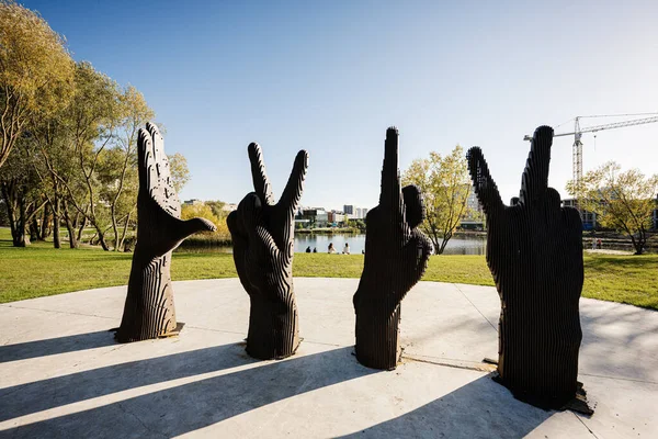 stock image Lviv, Ukraine - October 09, 2022: Metal sculpture of four hands. Looking at their gestures read the letters LVIV.