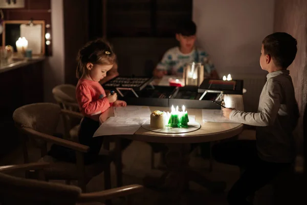 Stock image Family spending time together during an energy crisis in Europe causing blackouts. Kids drawing in blackout.