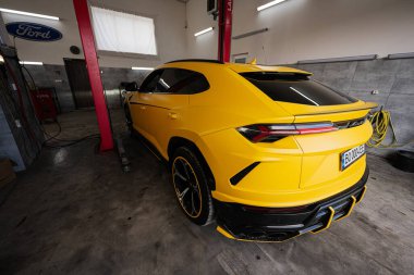 Ternopil, Ukrayna... 11 Kasım 2022: Sarı Lamborghini Urus otomobil servis istasyonunda.