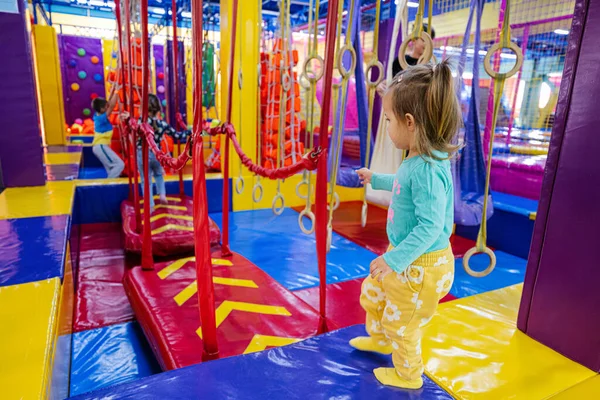 Happy kids playing at indoor play center playground.