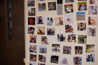 Ternopil, Ukraine - January 11, 2023: Refrigerator door filled by lots of memorial family photo.