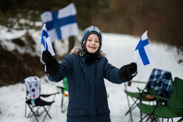 stock image Finnish boy with Finland flags on a nice winter day. Nordic Scandinavian people. 