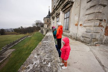 Mother with four kids visit balcony Pidhirtsi Castle, Lviv region, Ukraine. Family tourist. 