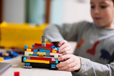 Ternopil, Ukraine - February, 2023: Boy kid constructing toy use Lego Classic at home.
