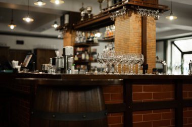 Empty bar with old barrel interior,  wooden furniture and pub counter without bartenders.